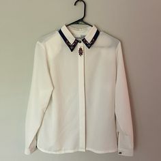 Gorgeous Vintage Women’s Blouse Button Down. With Beautiful Embroidery. P2p 20 Inches Size 8. Has Not Been Worn Before And In Brand New Condition! Feel Free To Check Out My Closet And Bundle To Save 10% Kind Offers Welcome! Collared Tops With Embroidered Cuffs For Work, Workwear Blouse With Embroidered Cuffs, Embroidered Cuffs Blouse For Workwear, Embroidered Collared Tops For Work, Classic Long Sleeve Tops With Embellished Collar, Classic Long Sleeve Top With Embellished Collar, Classic Workwear Tops With Embellished Collar, Elegant Workwear Shirt With Floral Embroidery, Classic Tops With Embellished Collar For Workwear