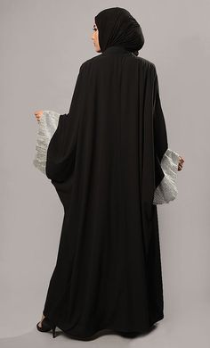 Featuring an asymmetrical and flared kaftan style abaya dress in nida fabric adorned with contrast color sequins embellishment on the edges of loose flowy sleeves. Its a beautiful eveing wear and trendy abaya dress.FIT : Relaxed fit.COMPOSITION : Nida.CARE : Dry clean only. Flowy Maxi-length Abaya For Eid, Flowy Long Abaya For Eid, Elegant Flowy Abaya For Eid, Elegant Eid Abaya With Cape, Elegant Black Cape Abaya, Elegant Black Tunic Abaya, Black Tunic Abaya For Eid, Floor-length Khimar For Eid, Trendy Abaya