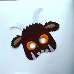 a paper mask with an animal's head on it and shamrock leaves around it