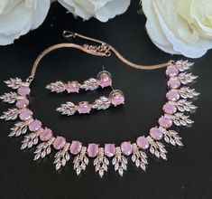 Rosegold Diamond Necklace Set featuring stunning pink moonstones and high-quality CZ stones. This sophisticated cocktail jewelry set is perfect for Indian and Pakistani special occasions. The matching earrings are approximately 1.5 inches long and lightweight at just 0.2 oz, offering both beauty and comfort. Our products are meticulously handcrafted, ensuring each piece is unique. Due to the manual craftsmanship, you may notice slight irregularities, which are natural and do not compromise the quality of the jewelry. Pink Round Stone Necklace, Pink Necklace With Stones, Necklace Set Diamond, Jewelry Pakistani, Pink Moonstone, Cocktail Jewelry, Diamond Necklace Set, Pakistani Jewelry, Rose Gold Diamonds