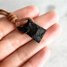 Elevate your energy with our Elite Shungite Pendant. Each piece is one-of-a-kind, handcrafted to showcase the purifying energy and protective properties of Elite Shungite. Experience vitality and protection in an elegant design. Elite Shungite, Chakra Activation, Gemstone Pendant Necklace, Pure Energy, Gemstone Necklace Pendant, Waxed Cotton, Glass Necklace, Natural Leather, Leather Cord