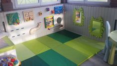 a child's playroom with green and yellow flooring