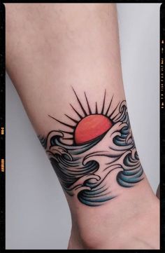 a sun and waves tattoo on the wrist is shown in this photo, it looks like an ocean wave