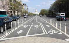 a bike lane on the street with cars parked in it