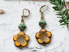 Elevate your boho chic style with these stunning dangle earrings featuring vibrant orange Czech glass flower beads paired with eye-catching turquoise Picasso glass bicone beads. The unique combination of colors and textures adds a playful touch to any outfit. You can choose your preferred earwires to suit your personal style. These earrings are the perfect accessory to make a statement with a pop of color and bohemian charm. These earrings are sure to be a favorite in your jewelry collection! 𝐋 Bohemian Orange Flower Beaded Earrings, Yellow Bohemian Nickel-free Flower Earrings, Bohemian Beaded Earrings With Flower Charm, Bohemian Czech Glass Dangle Flower Earrings, Bohemian Gold Flower Earrings For Beach, Handmade Bohemian Flower Earrings With Czech Glass, Bohemian Wire Wrapped Flower Earrings, Bohemian Czech Glass Flower Earrings, Bohemian Flower Earrings With Czech Glass