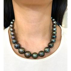 This beautiful black Tahitian pearl necklace ranges from 12 mm to 16.30 mm. The clasp has 114 round brilliant diamonds weighing 2.25 ct. The diamonds boast a color of E/F, are VS1 in clarity and are set in 18k white gold. A perfect piece for everyday wear! Tahitian Pearl Necklace, Tahitian Black Pearls, Tahitian Pearls, Brilliant Diamond, Tahiti, Round Brilliant, Pearl Necklace, Everyday Wear, Beaded Necklace