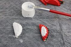 a red and white toothbrush sitting on top of a table next to some food