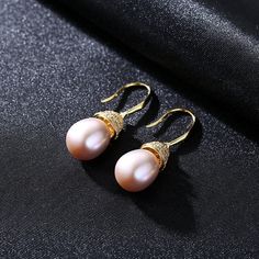 Enhance your natural glow with the right kind of luster, through the splendor of real pearl earrings. Less is definitely more when it comes to these dainty, yet utterly radiant white pearl drop earrings that capture the light from every angle. Measuring 10mm, the Freshwater pearl earrings are the ideal jewelry piece to compliment your wardrobe. our earrings come in fine settings: 14K yellow gold. * Buy over 2 pieces and get a medium jewelry organizer * Buy over $100 and get a large mirror jewelr Formal Rose Gold Pear-shaped Pearl Earrings, Elegant High Luster Pearl Earrings Gift, Rose Gold Pearl Drop Earrings Fine Jewelry, Fine Jewelry Rose Gold Pearl Drop Earrings, Rose Gold Pearl Charm Earrings For Anniversary, Pear-shaped High Luster Pearl Earrings, Classic Rose Gold Pearl Drop Earrings, Pear-shaped High Luster Pearl Earrings Gift, Rose Gold Teardrop Pearl Earrings For Anniversary