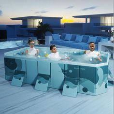 three children sitting in an outdoor jacuzzi with blue couches and sofas behind them