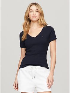 Tommy Hilfiger women's T-shirt. Made from soft, comfortable medium weight cotton, our Favorite Tees are designed to fit your form. Another reason to love them? They layer just as easily under a blazer as they do a zip hoodie, and work as a standalone piece.  Material: 100% Cotton. Fitted V-neck T-shirt For Everyday, Trendy Tommy Hilfiger Cotton T-shirt, Classic Tommy Hilfiger T-shirt For Summer, Classic Tommy Hilfiger Summer T-shirt, Classic Fitted V-neck Top, Classic V-neck Fitted Top, Spring Stretch Top By Tommy Hilfiger, Tommy Hilfiger Stretch Top For Spring, Trendy Tommy Hilfiger Tops For Spring