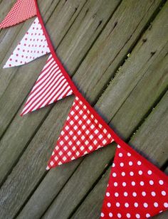 red and white polka dot buntings hanging from a wooden fence