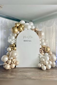 a white and gold wedding arch with balloons