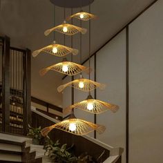 an artistic chandelier with five lights hanging from it's sides in a hallway