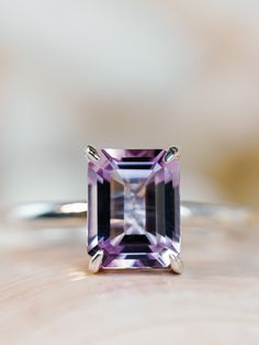 This classic solitaire setting contains a beautiful 2.5ct natural Rose De France amethyst. The emerald cut stone measures approximately 9x7mm and the band is 2mm wide. The ring is available in sterling silver, and 14k white, yellow, or rose gold.  This ring makes a unique promise or engagement ring.  Please send me a message if you need a size not listed.  *  This ring can be customized with any color center stone. All items are handmade by me in my shop in Manalapan, NJ.  Please message me with Luxury Faceted Amethyst Ring In Fine Jewelry Style, Luxury Lavender Amethyst Ring Elegant Style, Luxury Fine Jewelry Silver Amethyst Ring, Luxury Classic Amethyst Ring With Gemstone Accents, Luxury Modern Amethyst Ring With Diamond, Amethyst Engagement Ring White Gold, Amythest Engagement Rings, Emerald Cut Amethyst Ring, Lavender Amethyst Engagement Ring