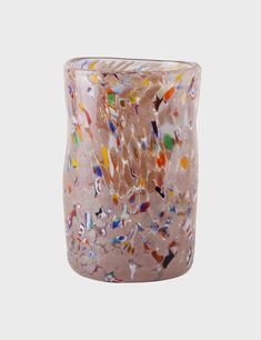 a glass vase with multicolored designs on it