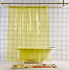 a yellow shower curtain hanging over a bathtub