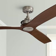 a ceiling fan with a wooden blade and light on top of the blades in a room