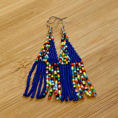 These African Maasai Zulu Style inspired Tribal earrings are definitely a standout. If you love African jewelry styles and these statement earrings, these are your earrings. Blue Beaded Festival Earrings With Ear Wire, Blue Beaded Earrings For Festival With Ear Wire, Traditional Blue Drop Chandelier Earrings, Adjustable Blue Tassel Earrings With Colorful Beads, Blue Tassel Drop Earrings, Blue Beaded Drop Earrings For Festival, Blue Tassel Drop Earrings For Festival, Blue Bohemian Plug Earrings, Blue Bohemian Plug Earrings For Pierced Ears