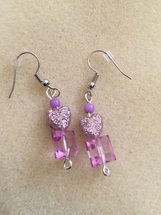 Earrings in pinkish/ purplish sparkle Purple Beaded Earrings For Party, Pink Pierced Earrings As Gift, Purple Dangle Heart Earrings For Pierced Ears, Pink Crystal Dangle Earrings With Ear Wire, Cute Purple Jewelry For Party, Adjustable Pink Pierced Hoop Earrings, Cute Purple Party Jewelry, Cute Pink Glitter Earrings, Pink Crystal Ear Wire Earrings For Gift