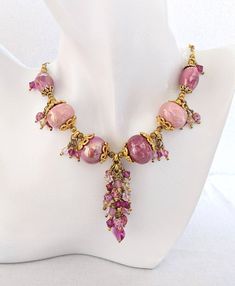 Handmade jewelry in France This necklace was made entirely by hand. The pearls have been mounted on a cabled thread, an ideal material to ensure flexibility, resistance, longevity and above all a good hold for your pearl jewellery. It is made of high quality materials: - Iridescent pink ceramic beads - Swarovski crystal beads in pink, light pink, fuchsia and crystal brandy colors - Faceted beads in speckled pink and opal pink Bohemian crystal - Chain, clasp and findings in fine gold-plated metal Pink Bohemian, Bohemian Crystal, Wire Jewelry Designs, Pearl Jewellery, Pink Ceramic, Light Rose, Swarovski Crystal Beads, Crystal Chain, Chic Jewelry