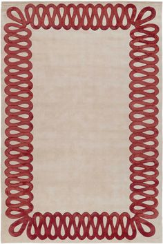 a red and beige area rug with an intricate design on the border, in front of a white background