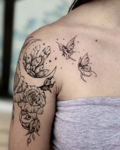 a woman's shoulder with flowers and butterflies on it