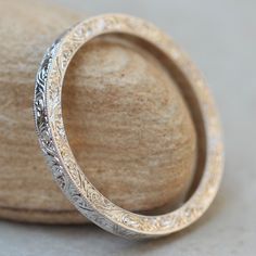 a close up view of a wedding ring with filigrees on the side