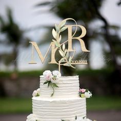 a wedding cake with the initials mr and mrs on top