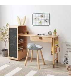 a wooden desk with two stools and a chalkboard on the wall