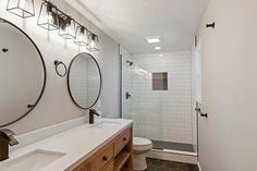 a bathroom with two sinks and a shower