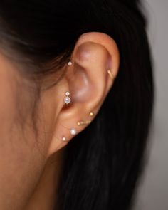 a close up of a person wearing ear piercings