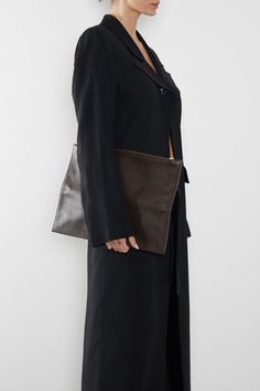 The Slimline in smooth dark brown is the ultimate clutch for a modern minimal aesthetic. Each piece is secured by invisible magnets and opens to pouch size. The 2 in 1 piece exudes a slender, elegant style with a surprisingly functional form. Carry hand-held, folded or flat with a large wallet-like look. Handcrafted exclusively in the A-ESQUE Melbourne Atelier from the finest soft smooth Italian leather. Delivered in an exclusive A-ESQUE cotton drawstring storage bag for preservation and luxury. Elegant Workwear Clutch With Magnetic Closure, Elegant Clutch With Magnetic Closure For Work, Elegant Workwear Clutch With Removable Pouch, Sleek Leather Rectangular Clutch, Modern Structured Clutch For Formal Occasions, Sleek Rectangular Leather Clutch, Rectangular Workwear Clutch With Removable Pouch, Versatile Rectangular Clutch For Work, Rectangular Clutch With Removable Pouch For Work