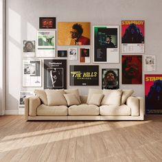 a living room filled with furniture and posters on the wall above it's windows