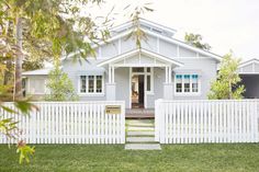 a white picket fence in front of a house