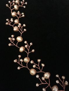 a close up of a necklace with pearls on it