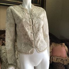 Brand New, Never Worn, No Tags. Elie Tahari Embroidered Cropped Mandarin Collar Intricate Blazer Jacket. Slightly Cropped Length. Stunningly Intricate Embroidery, All Hand Done. Lightweight And Elegant. Colors Are Off White Cream Ivory Colored Base With Light Tan Embroidery. 100% Cotton. Hook And Eye Closures Down Front. Size S. Elegant Embroidered Spring Outerwear, Elegant Fall Outerwear With Gold Embroidery, Elegant Fitted Outerwear With Gold Embroidery, Elegant Silk Outerwear With Intricate Embroidery, Elegant Long Sleeve Outerwear With Gold Embroidery, Silk Outerwear With Intricate Embroidery For Spring, Elegant Silk Outerwear With Embroidery, Formal White Embroidered Outerwear, Elegant Embroidered Silk Outerwear