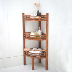 a bathroom corner shelf with soaps and other items on the shelves in front of it