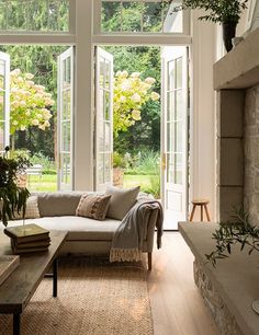 a living room filled with furniture and windows