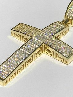 "Stunning Iced Out Moissanite Cross Pendant 2.53 ct VVS D color REAL moissanite stones. PASSES DIAMOND TESTER ANY PEN OR LIGHT TRANSMISSION DIAMOND TESTER (Will show up as moissanite and not diamond on lab assays however) Measures roughly 2\" by 1.5\" (2.5\" with bale) weighs a solid 20 grams! Fits most Chains up to 8mm thick Heavy and Solid piece! 14k yellow gold vermeil Solid 925 sterling silver Will never change color or go green!! Look just like natural diamonds and without microscope you ca Gold Moissanite Bling Necklace, Gold Iced Out Cross Pendant Jewelry, Iced Out Gold Cross Pendant Jewelry, Gold Moissanite Iced Out Necklaces, Hallmarked Gold Moissanite Jewelry, Gold Diamond Cut Moissanite Jewelry, Gold Moissanite Jewelry With Diamond Cut, Gold Vvs Clarity Cross Pendant Jewelry, Gold Jewelry With Vvs Clarity Cross Pendant