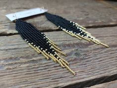 Black - gold seed bead earrings. The peculiarity of these earrings is that the ends of the fringe are made of mini beads of a gold color. Handmade from high quality Czech beads. Measurements: Length - 4.7 inch (12 cm) Width - 0.78 inch (2 сm) * Real colors may slightly differ from one monitor to another, as it depends on specific monitor settings. *Thank you for shopping at IrinaJewelryBox. If you have any questions, please contact me! *Back to my shop https://www.etsy.com/shop/IrinaJewelryBox?ref=hdr Elegant Black Earrings With Tiny Beads, Black Beaded Fringe Earrings As Gift, Gold Tassel Dangle Earrings With Tiny Beads, Gold Tassel Earrings With Tiny Beads, Elegant Black Beaded Earrings With Tiny Beads, Gold Beaded Fringe Earrings With Adjustable Fit, Black Tassel Earrings With Dangling Beads As Gift, Gold Beaded Earrings With Black Beads For Party, Gold Dangle Earrings With Black Beads