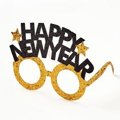 a pair of glasses with the words happy new year spelled out in black and gold glitter