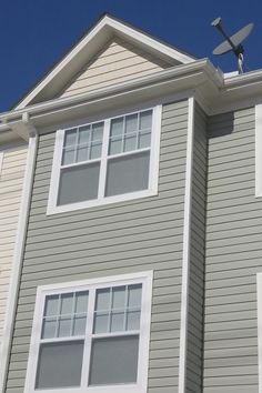 a satellite dish is on top of the roof of a house