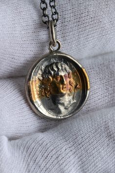 Greek god of the sun, Helios crafted as a sterling silver pendant accented with a strip of 24K gold. God Of The Sun, Greek God, Stone Gold, Greek Gods, Sterling Silver Pendant, Gold And Silver, Pocket Watch, Gold Pendant, Sterling Silver Pendants