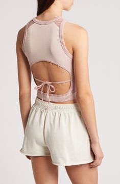 This cool cropped tank is crafted in a close-fitting silhouette with a tied-and-cutout back. 15" length (size Medium) Ties at back Crewneck Sleeveless 38% polyester, 35% recycled polyamide, 21% polyamide, 6% elastane Machine wash, line dry Made in Turkey Casual Crop Top With Built-in Bra And Strappy Back, Beach Tank Crop Top With Built-in Bra, Spring Cropped Sports Bra With Built-in Bra, Fitted Crop Top With Lace-up Back For Spring, Fitted Lace-up Back Crop Top For Spring, Spring Crop Top Sports Bra With Built-in Bra, Spring Stretch Tops With Lace-up Back, Sleeveless Top With Lace-up Back For Spring, Chic Cropped Top For Workout