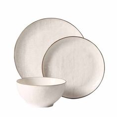 three white plates and two bowls on a white background