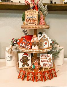 a three tiered christmas tree with gingerbreads and cookies on the bottom shelf