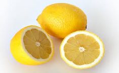 two lemons cut in half on a white background