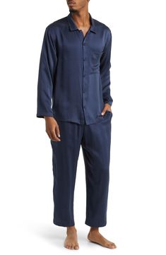 A classic button-up top pairs with matching bottoms in breathable silk pajamas that feel like a dream and can be cleaned in the washing machine. Top has front button closure; long sleeves; chest patch pocket Bottoms have elastic waist; side-seam pockets 100% silk Machine wash, dry flat Imported Blue Sleepwear With Button Closure For Loungewear, Casual Silk Sleepwear For Pajama Party, Blue Button-up Sleepwear With Button Closure, Silk Casual Sleepwear For Pajama Party, Long Sleeve Sleepwear With Button Cuffs For Loungewear, Blue Sleepwear With Button Closure, Long Sleeve Sleepwear With Button Cuffs, Casual Silk Sets With Long Sleeve, Casual Silk Long Sleeve Sets