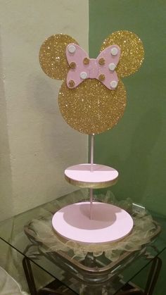 there is a cake stand with minnie mouse ears on it