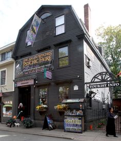 a black building with lots of signs on the front and side of it's windows